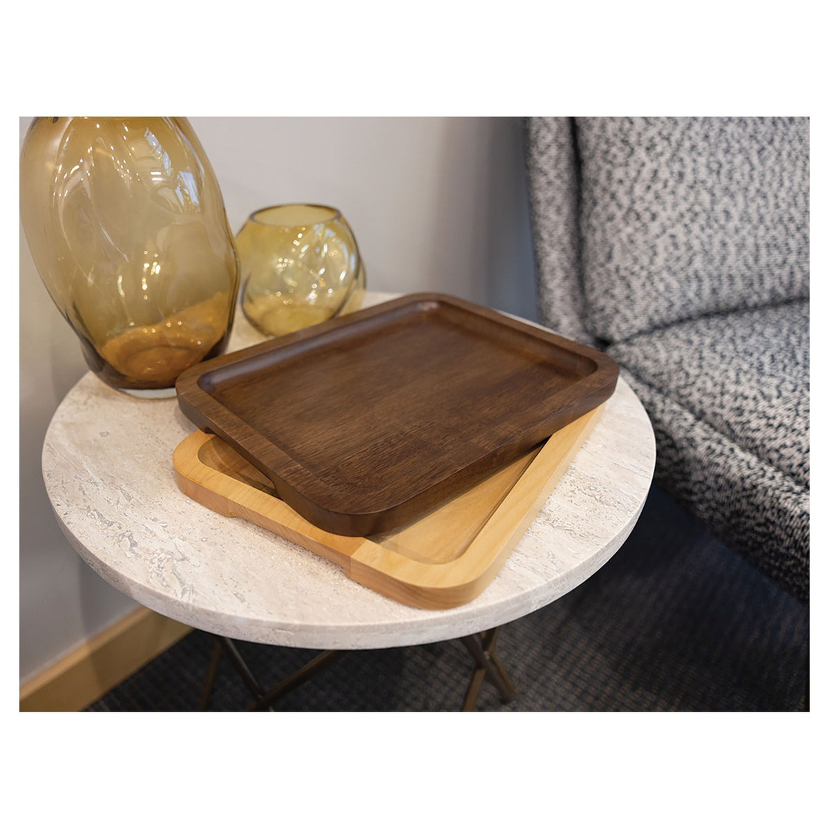 Engraved walnut and alder serving trays on a side table
